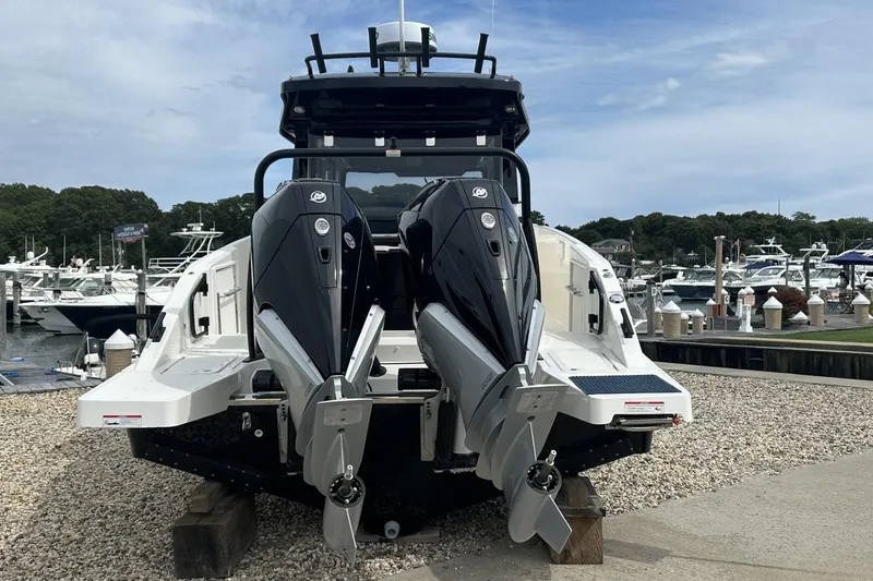 Slide: The Image of 2025 Navan C30 boat with dual outboard motors at a marina dock. - 2