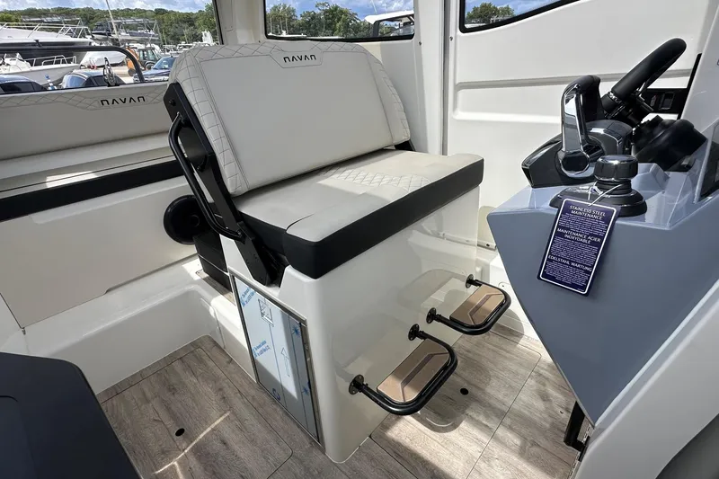 Slide: The Image of Interior of 2025 Navan C30 boat with seating and cup holders, docked at marina. - 22