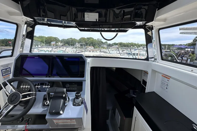 Slide: The Image of Interior view of 2025 Navan C30 boat, featuring seating and storage compartments. - 31