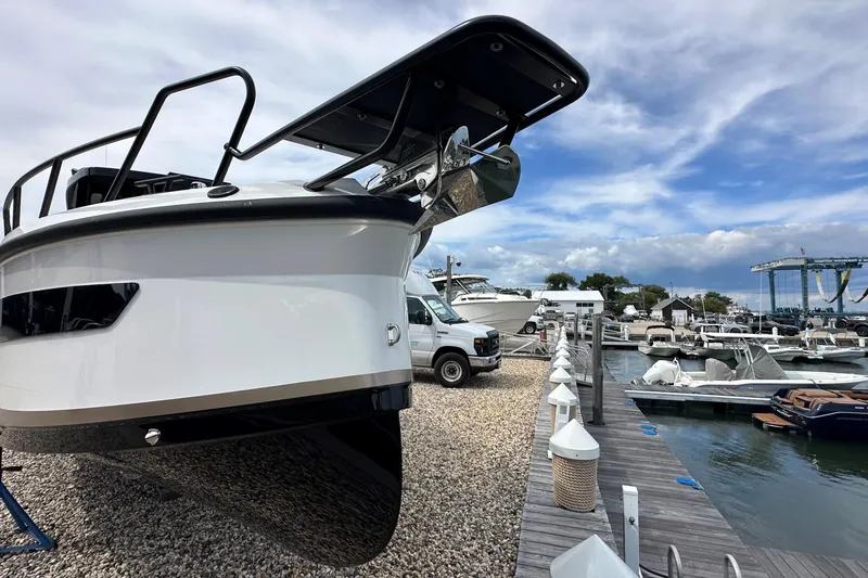 Slide: The Image of 2025 Navan C30 boat docked at a marina under a partly cloudy sky. - 51
