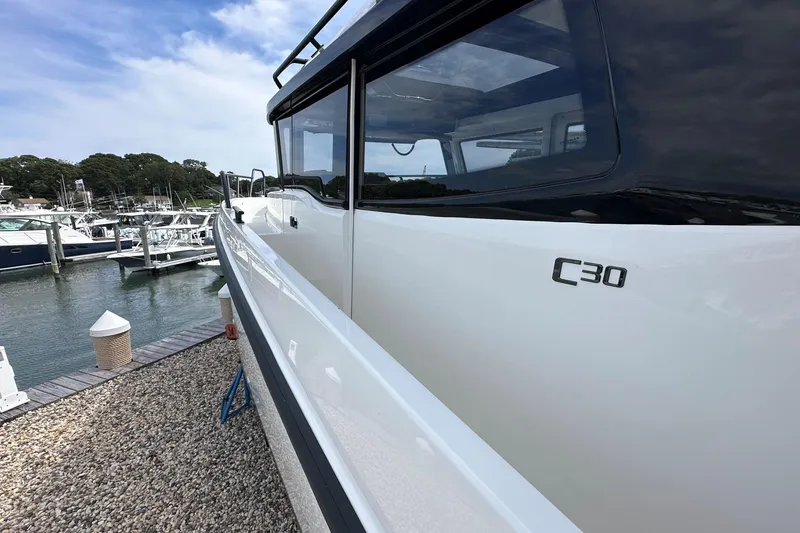 Slide: The Image of 2025 Navan C30 boat docked at marina, showcasing sleek design and modern features. - 52