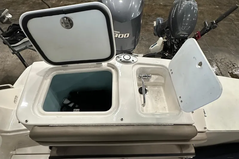 Slide: The Image of 2021 Cutwater C-24 CW boat with open storage compartments and Yamaha outboard motors. - 10