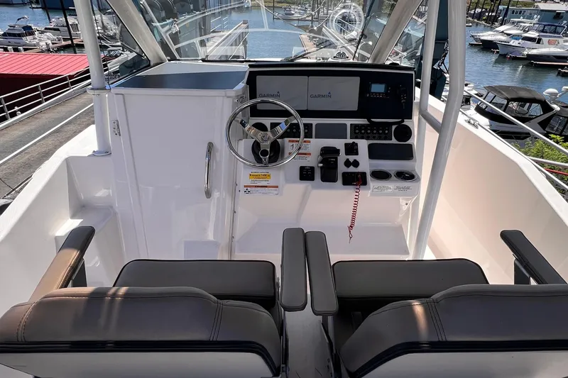 Slide: The Image of 2021 Cutwater C-24 CW boat cockpit with dual seats and Garmin navigation system. - 13
