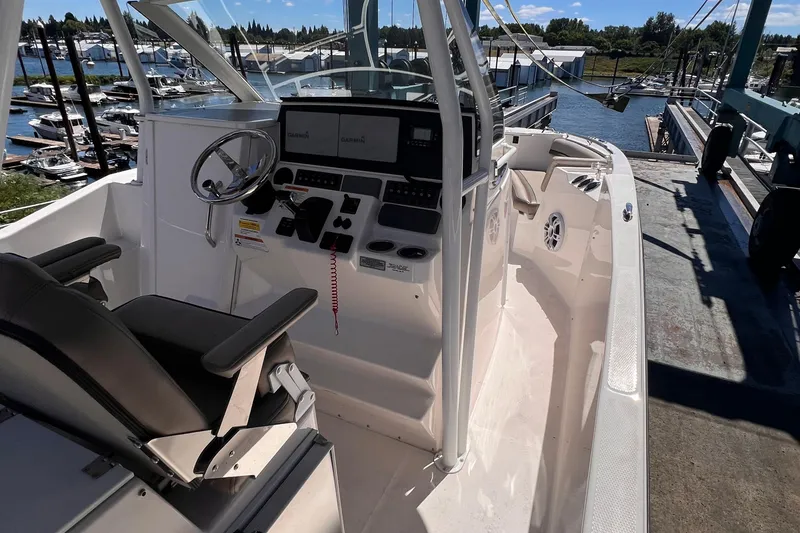 Slide: The Image of 2021 Cutwater C-24 CW boat interior with steering wheel and control panel at marina. - 14