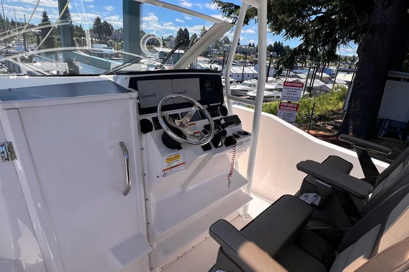 Slide: The Image of 2021 Cutwater C-24 CW boat helm with Garmin navigation, docked at a marina. - 15