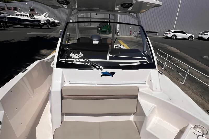 Slide: The Image of 2021 Cutwater C-24 CW boat, white exterior, docked with visible seating and windshield. - 19