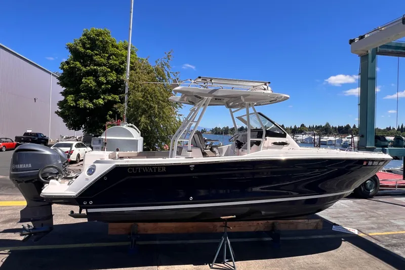 Slide: The Image of 2021 Cutwater C-24 CW boat on display with Yamaha engine, dockside setting. - 2