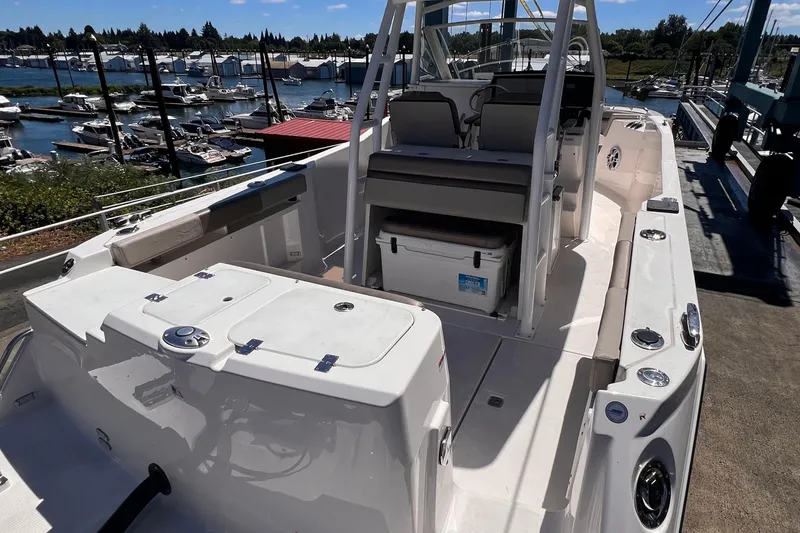 Slide: The Image of 2021 Cutwater C-24 CW boat interior with seating and storage, docked at a marina. - 9