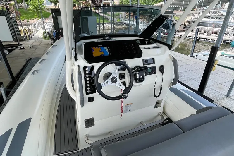 Slide: The Image of 2022 Brig Eagle 8 boat cockpit with steering wheel and navigation system. - 12