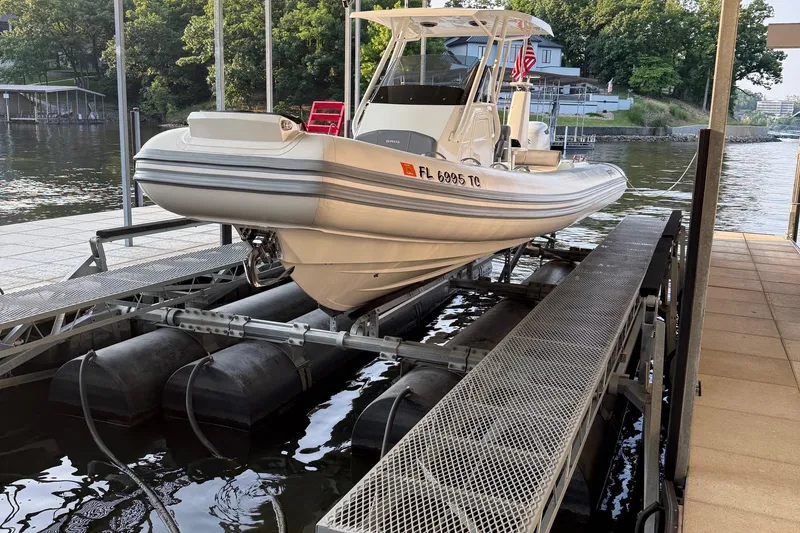 Slide: The Image of 2022 Brig Eagle 8 boat on a lift by a lakeside dock. - 5