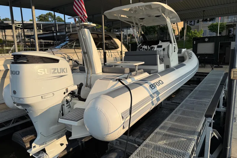 Slide: The Image of 2022 Brig Eagle 8 boat with Suzuki engine docked under a covered marina. - 7