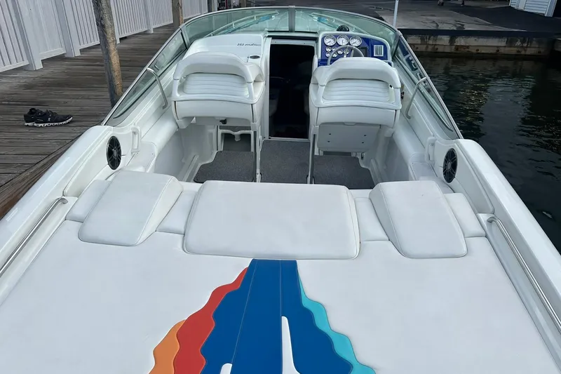 Slide: The Image of 1998 Formula 353 FASTech boat interior with white seating and colorful design accents. - 10