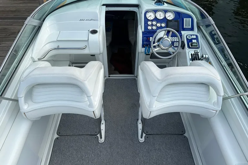 Slide: The Image of 1998 Formula 353 FASTech boat interior with white seats and blue dashboard. - 11