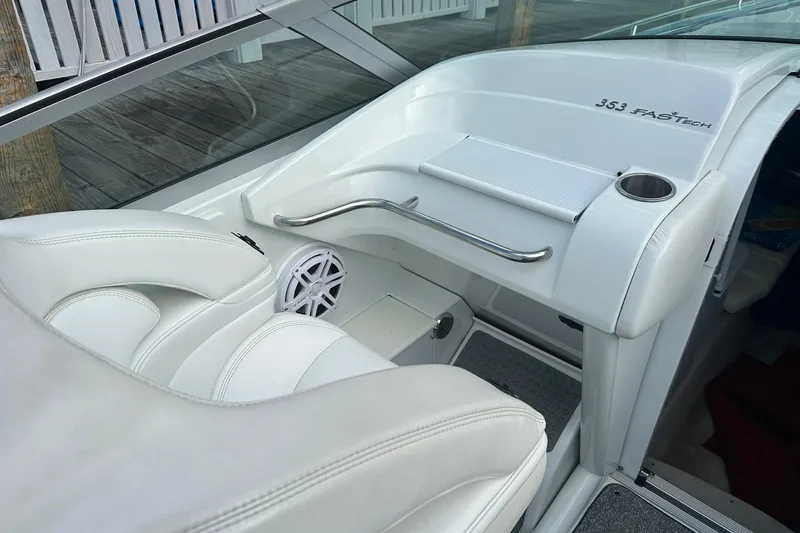 Slide: The Image of 1998 Formula 353 FASTech boat interior with white seating and dashboard details. - 12