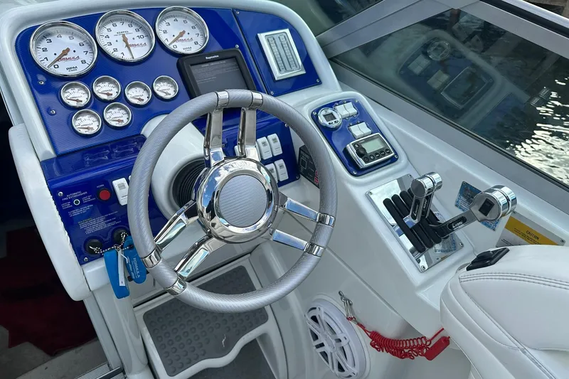 Slide: The Image of 1998 Formula 353 FASTech boat dashboard with gauges, steering wheel, and controls. - 13
