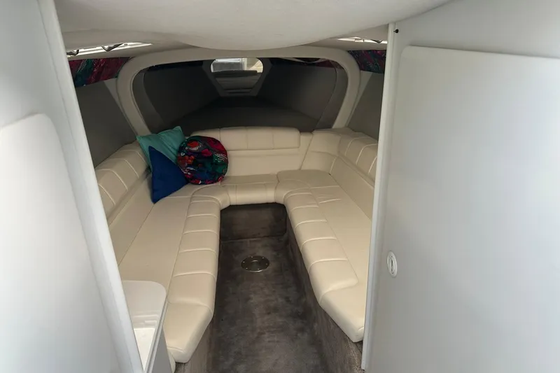 Slide: The Image of 1998 Formula 353 FASTech cabin interior with white seating and colorful pillows. - 21