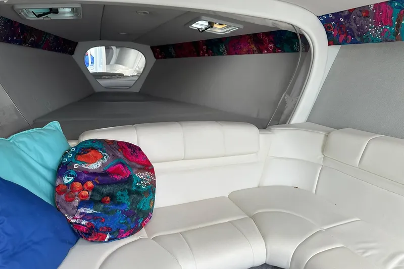 Slide: The Image of Interior of 1998 Formula 353 FASTech boat with white seating and colorful pillows. - 24