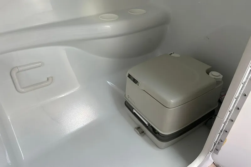 Slide: The Image of Portable toilet inside 1998 Formula 353 FASTech boat cabin, featuring a compact design. - 29