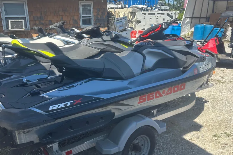 Slide: The Image of 2018 Sea-Doo RXT-X 300 jet ski on trailer, parked outdoors. - 5