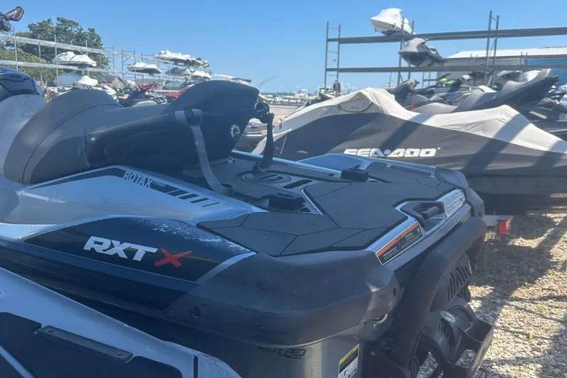 Slide: The Image of 2018 Sea-Doo RXT-X 300 jet ski parked in a marina storage area. - 6