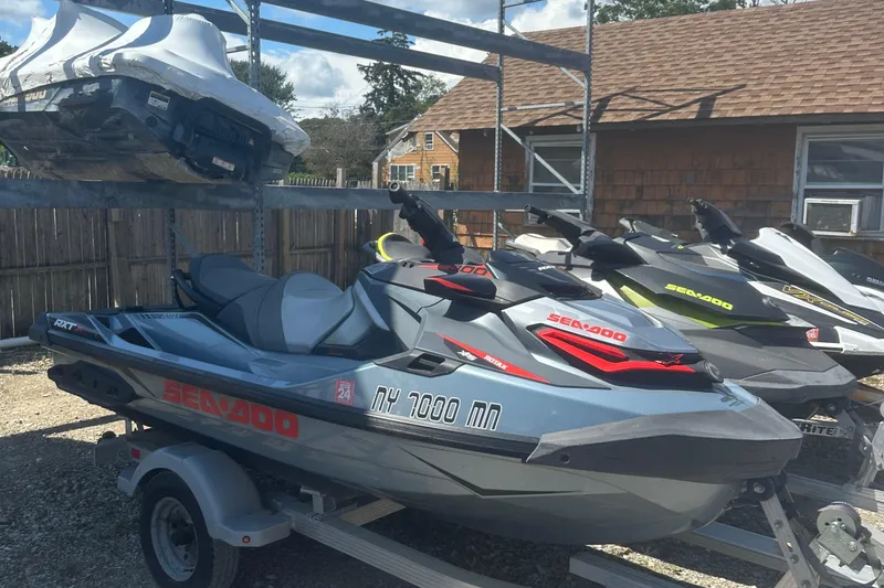 Slide: The Image of 2018 Sea-Doo RXT-X 300 jet ski on trailer, parked outdoors. - 7