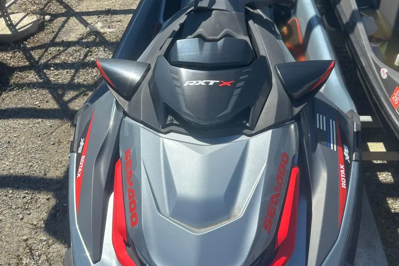 Slide: The Image of 2018 Sea-Doo RXT-X 300 jet ski, gray and red, parked outdoors. - 8
