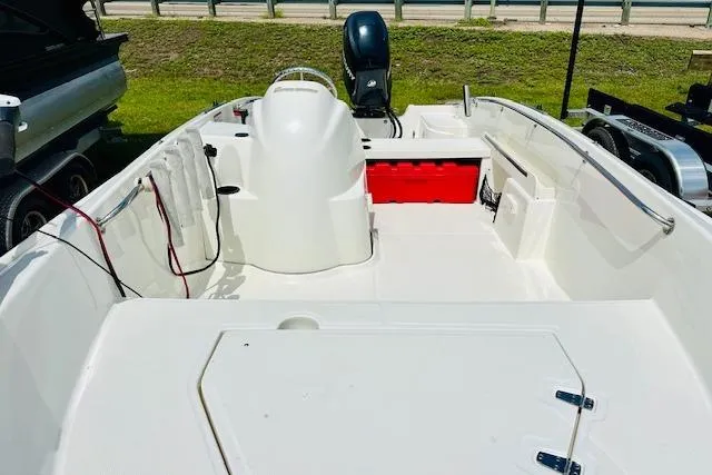 Slide: The Image of 2011 Boston Whaler 170 Super Sport boat interior with seating and storage compartments. - 10