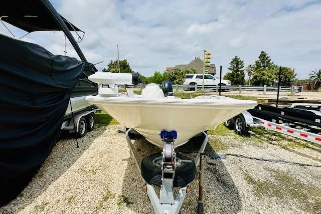 Slide: The Image of 2011 Boston Whaler 170 Super Sport boat on trailer, parked outdoors. - 13