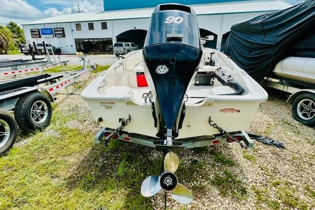 Slide: The Image of 2011 Boston Whaler 170 Super Sport boat with 90 HP engine, parked outdoors. - 3