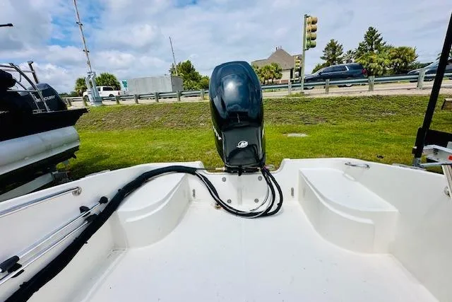 Slide: The Image of 2011 Boston Whaler 170 Super Sport boat with outboard motor, parked on grass. - 5