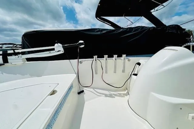Slide: The Image of 2011 Boston Whaler 170 Super Sport boat interior with rod holders and seating. - 8