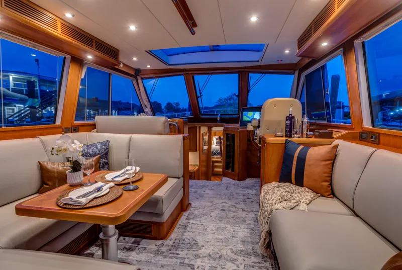 Slide: The Image of Luxurious interior of 2012 Grand Banks 46 Eastbay SX yacht with elegant seating and dining area. - 1