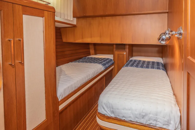 Slide: The Image of Twin cabin interior of 2012 Grand Banks 46 Eastbay SX yacht, featuring wooden finishes. - 10