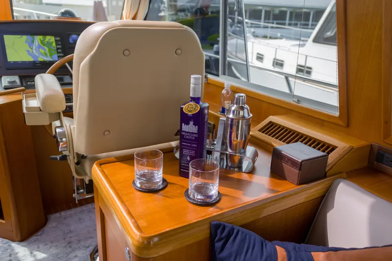 Slide: The Image of Luxurious interior of 2012 Grand Banks 46 Eastbay SX yacht with drinks and navigation equipment. - 18