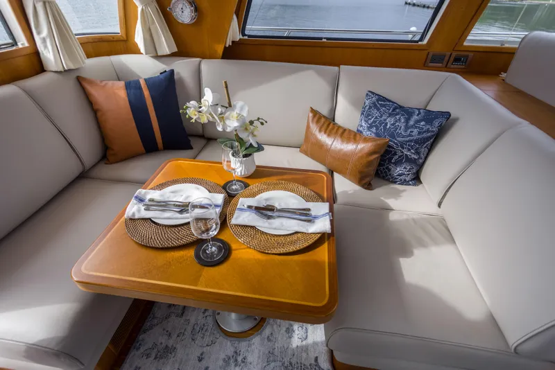 Slide: The Image of Luxurious dining area on 2012 Grand Banks 46 Eastbay SX yacht with elegant table setting. - 19