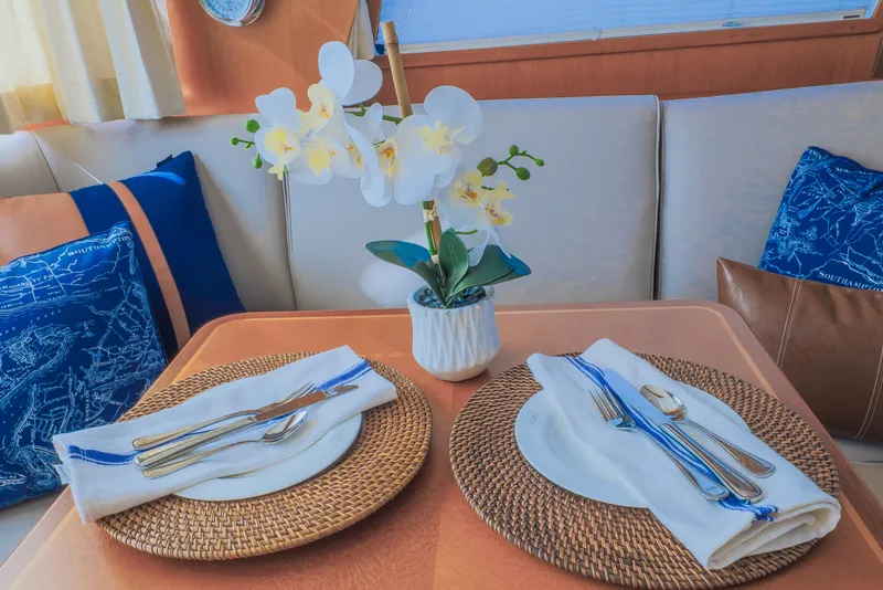 Slide: The Image of Elegant dining setup on 2012 Grand Banks 46 Eastbay SX yacht with floral centerpiece. - 20