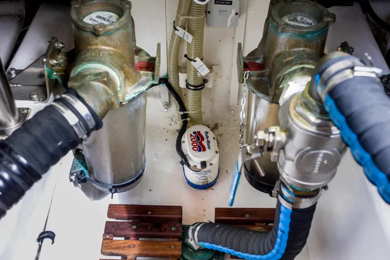 Slide: The Image of Engine room of 2012 Grand Banks 46 Eastbay SX with marine components and hoses. - 28