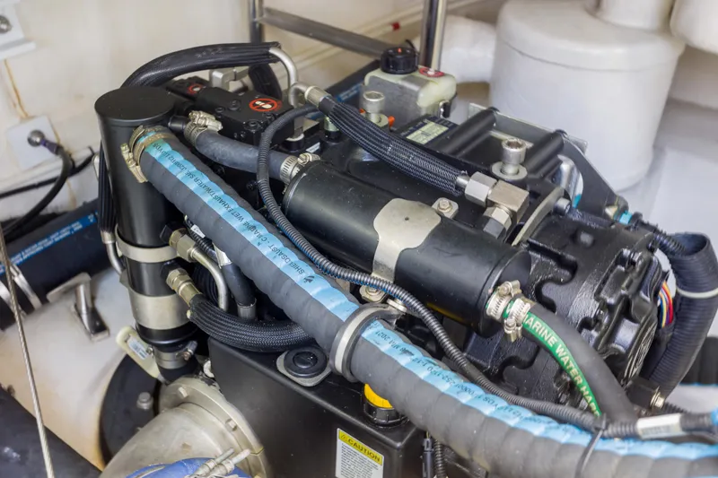 Slide: The Image of Engine compartment of 2012 Grand Banks 46 Eastbay SX with visible hoses and components. - 29