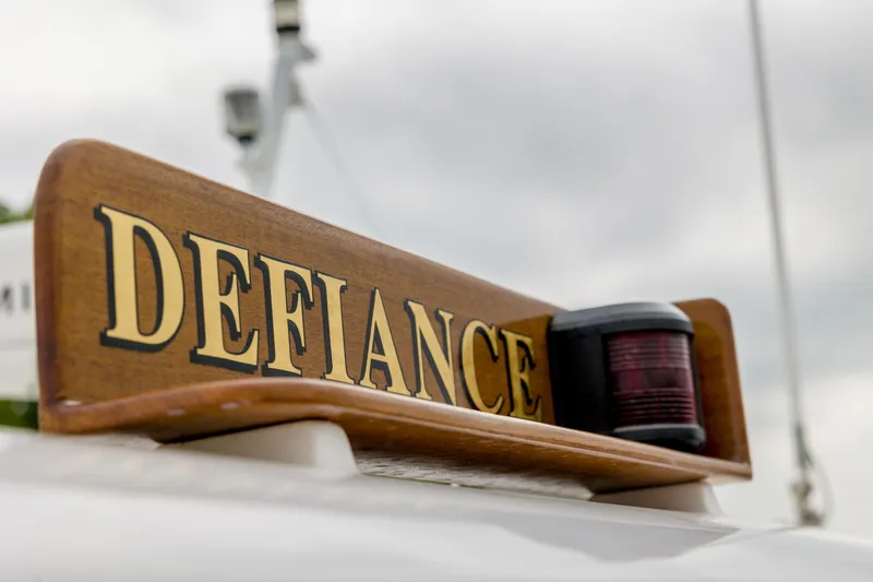 Slide: The Image of Wooden boat nameplate "Defiance" on 2012 Grand Banks 46 Eastbay SX. - 33