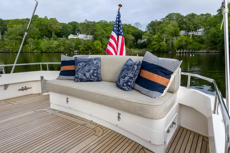Slide: The Image of 2012 Grand Banks 46 Eastbay SX yacht deck with cushioned seating and decorative pillows. - 43