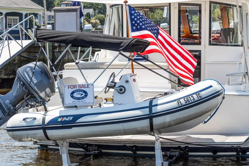 Slide: The Image of For sale: 2012 Grand Banks 46 Eastbay SX with dinghy and American flag. - 45