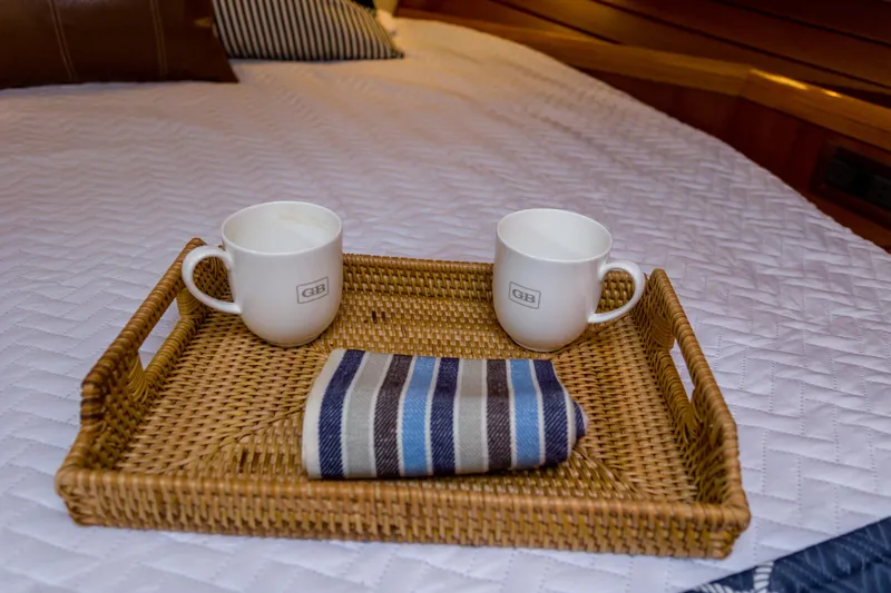 Slide: The Image of Wicker tray with mugs and napkin on Grand Banks 46 Eastbay SX yacht bed, 2012 model. - 8