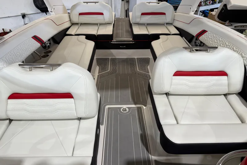 Slide: The Image of 2024 Regal LS6 boat interior with white and red seating, modern design, and spacious layout. - 11