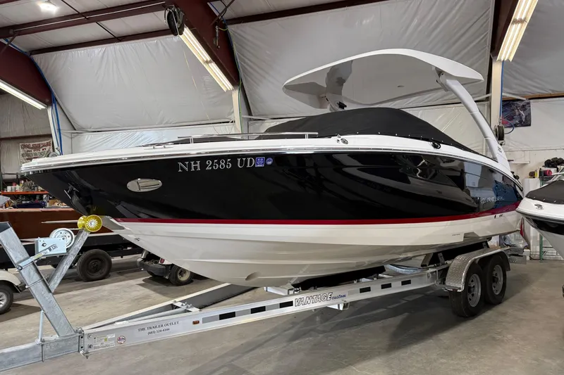 Slide: The Image of 2024 Regal LS6 boat on trailer in indoor storage facility. - 2