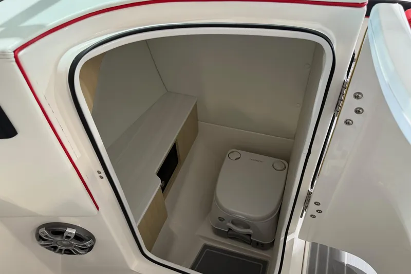 Slide: The Image of 2024 Regal LS6 boat interior with compact marine toilet and storage space. - 3