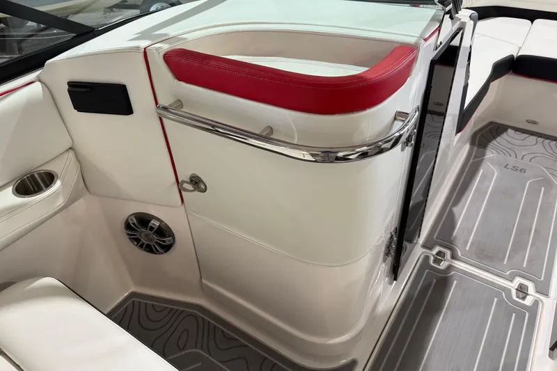 Slide: The Image of 2024 Regal LS6 boat interior with red accents, cup holder, and speaker. - 4