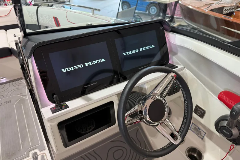 Slide: The Image of 2024 Regal LS6 boat dashboard with dual Volvo Penta displays and steering wheel. - 6