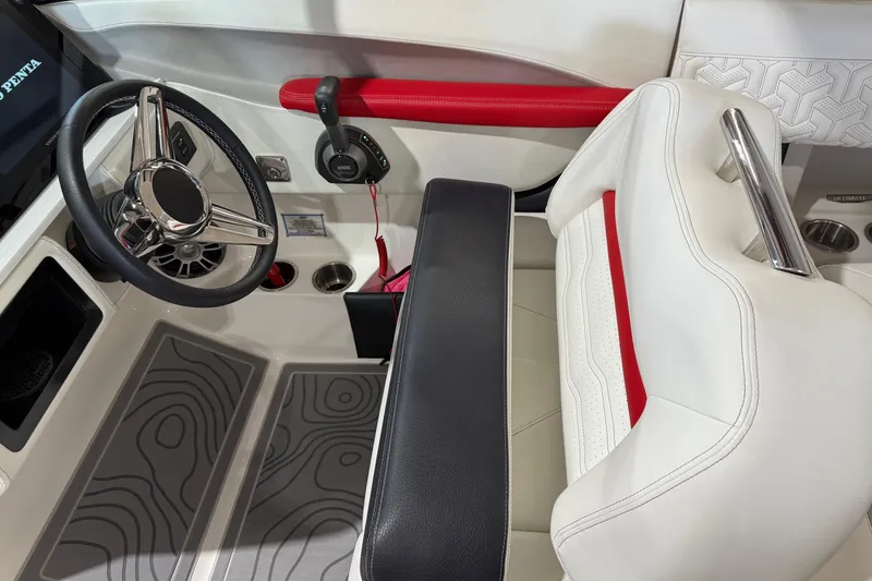 Slide: The Image of 2024 Regal LS6 boat interior with steering wheel, control panel, and white-red seating. - 7
