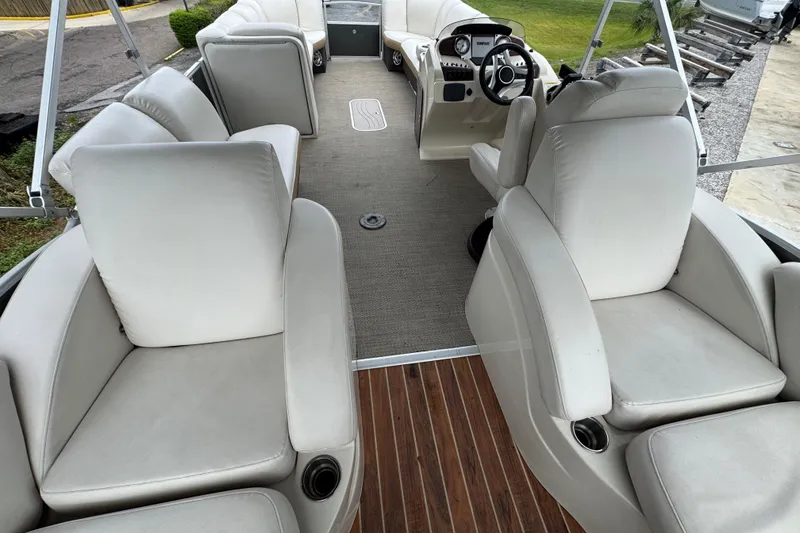 Slide: The Image of Interior of 2017 Sweetwater Premium Edition 255 SL pontoon boat with plush seating. - 5