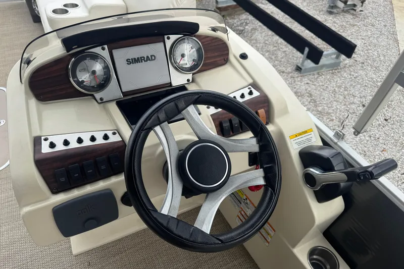 Slide: The Image of Steering console of 2017 Sweetwater Premium Edition 255 SL boat with Simrad display. - 7